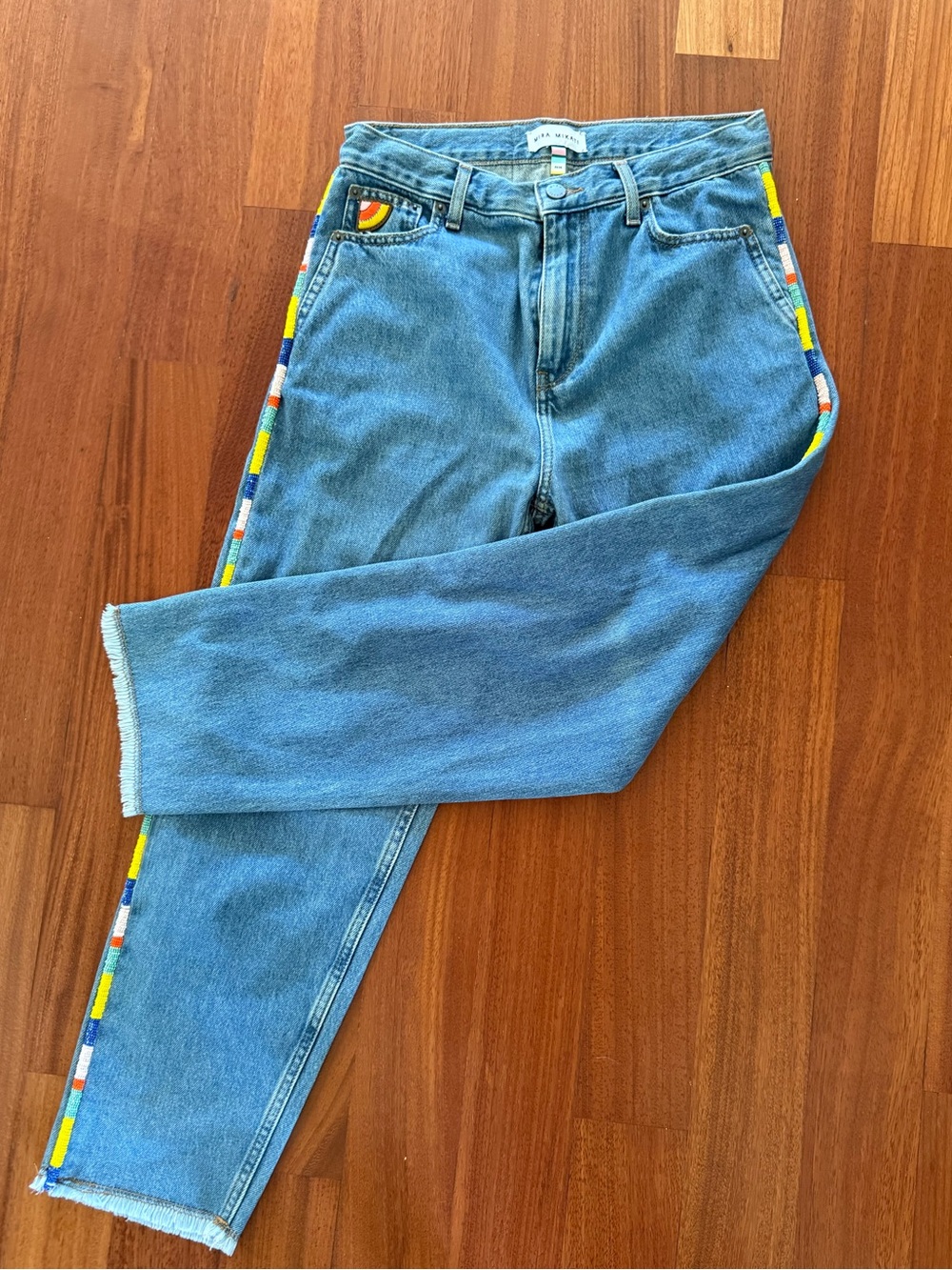 Mira mikati jeans with rainbow beading along the side
